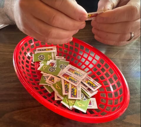 A basket of pull tabs being opened at the bar