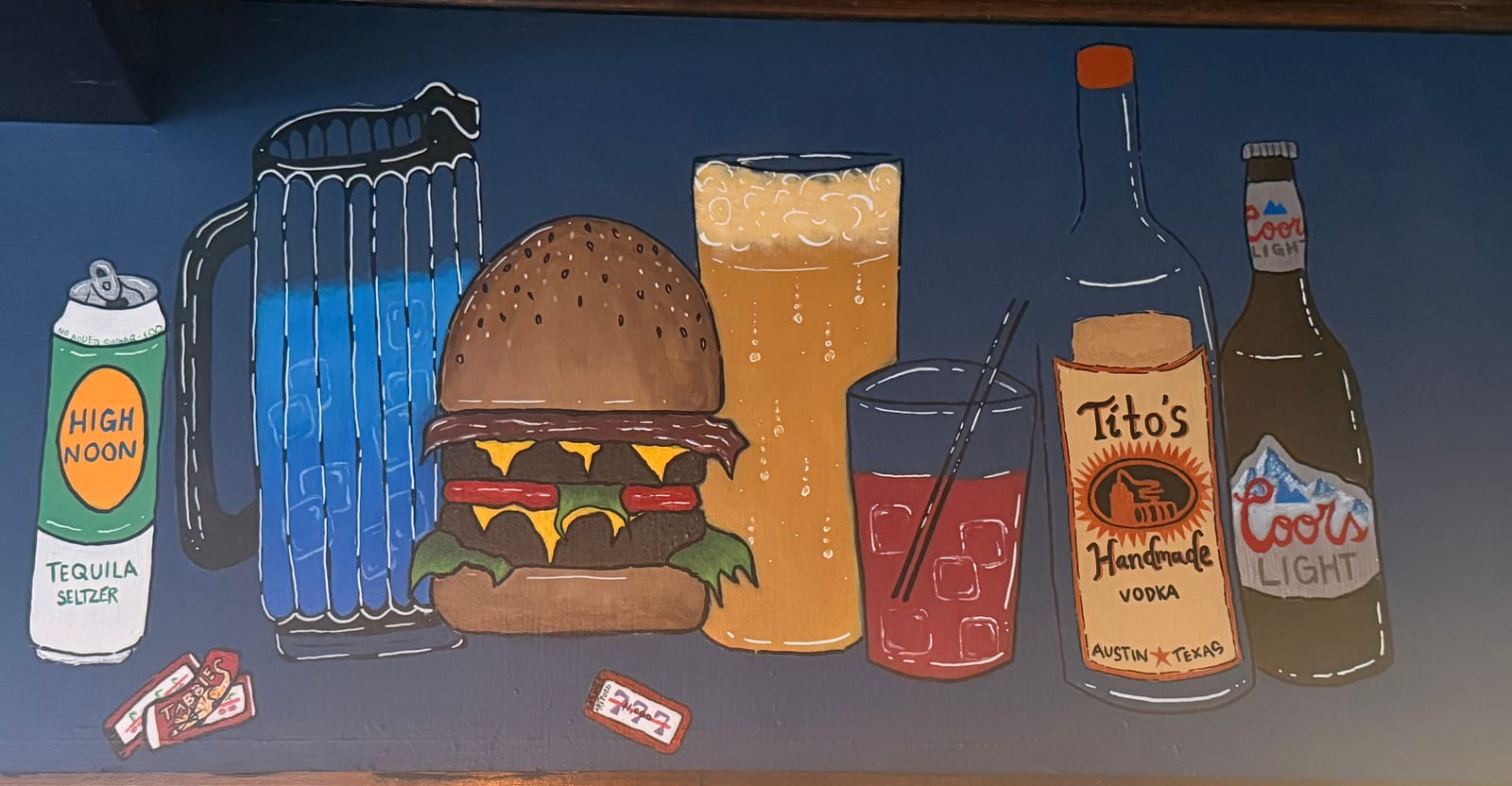 Hand-painted mural at Dax's showing a burger, a cold beer, a cocktail, High Noon, Tito's and Coors Light